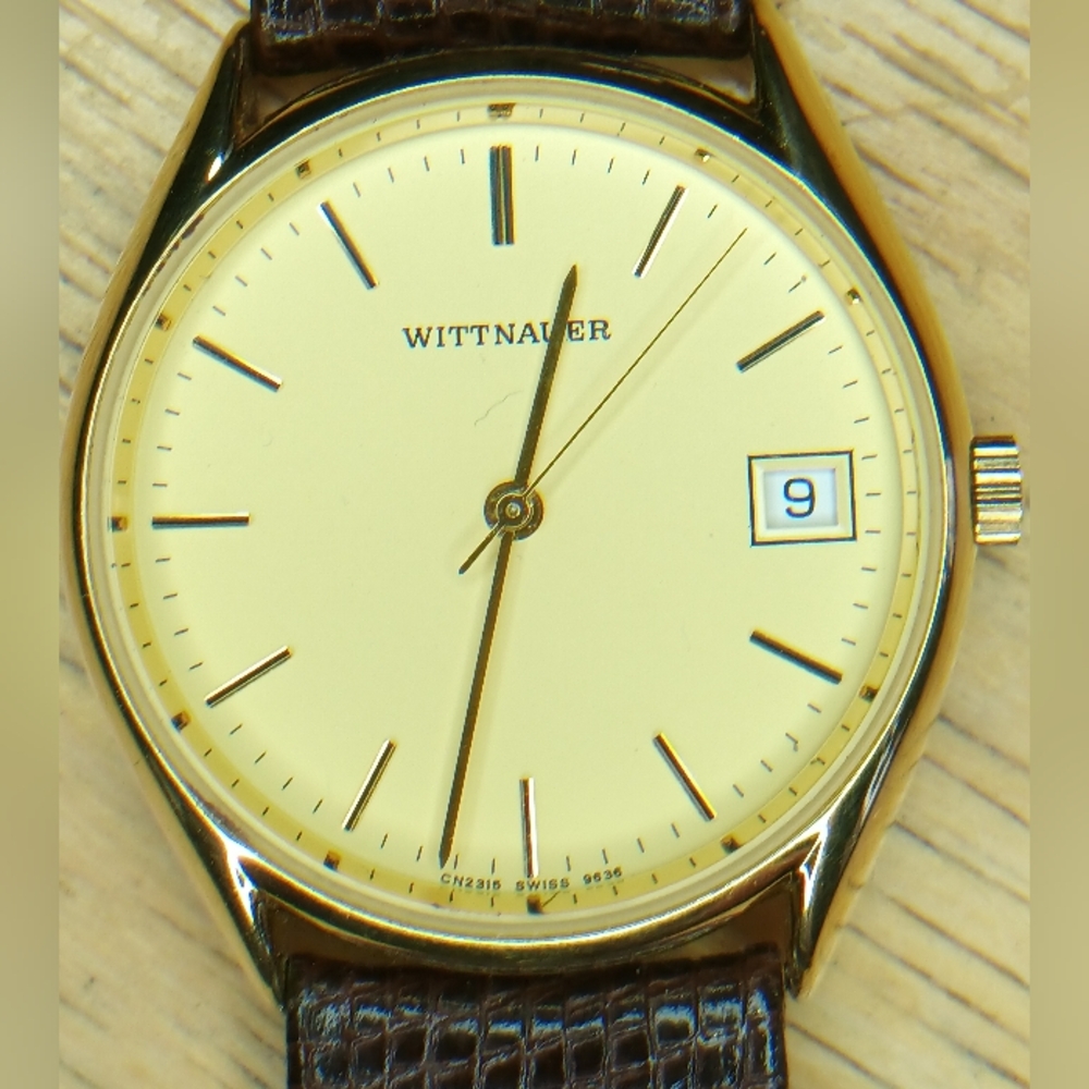 1993 Wittnauer Gold tone case, dial, brown leather band, 3 hand movement, date